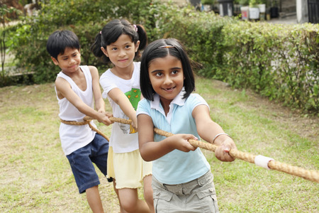 Children pulling rope togetherの写真素材