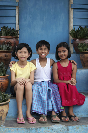 Children sitting on stairsの写真素材