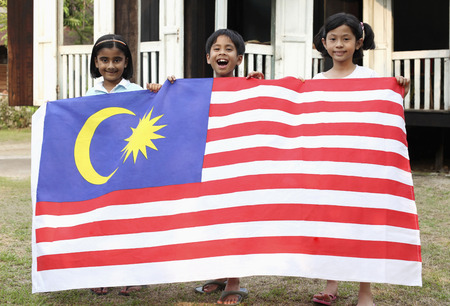 Children holding national flagの写真素材