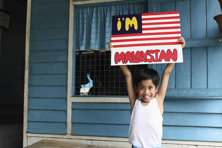 Boy holding up a posterの写真素材
