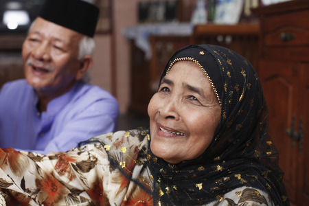 Senior man and woman smiling happilyの写真素材