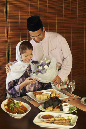 Man giving woman a bouquet of flowersの写真素材