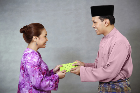 Woman receiving green packet from manの写真素材