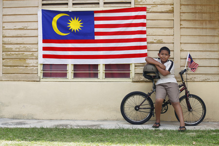 Boy sitting on bicycleの写真素材