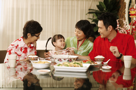 Man taking food for girl, woman and senior woman watchingの写真素材