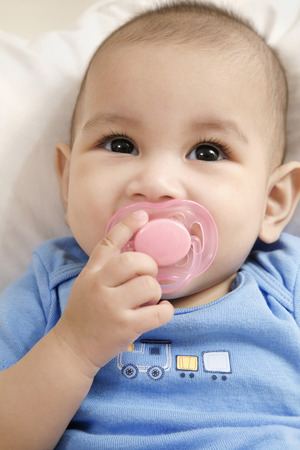 Baby sucking on pacifierの写真素材