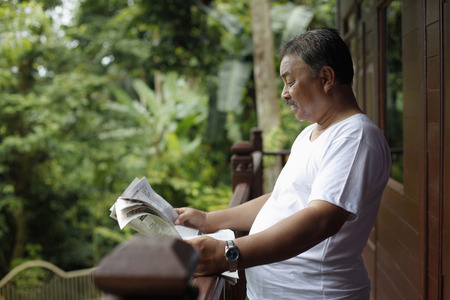 Senior man reading newspaperの写真素材