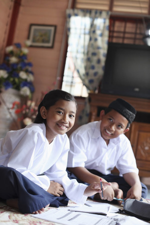 Children doing school homeworkの写真素材