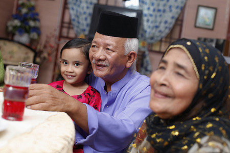 Senior man and woman with their granddaughterの写真素材