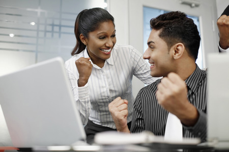 Businesspeople smiling and showing fistの写真素材
