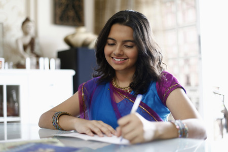 Teenage girl writing greeting cardの写真素材
