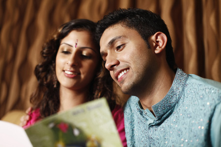 Man and woman reading greeting card togetherの写真素材