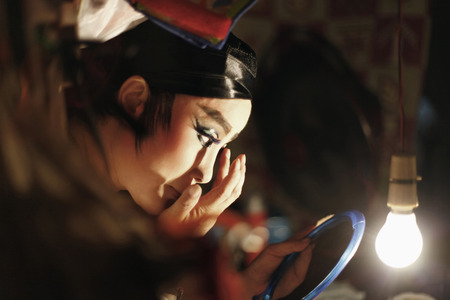 Opera performer applying make-upの写真素材