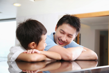 Man and boy waiting at the hotel receptionの写真素材