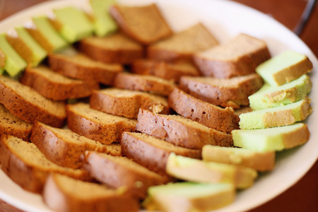 Slices of pandan and chocolate cake