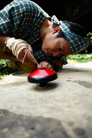 Man spinning a topの写真素材