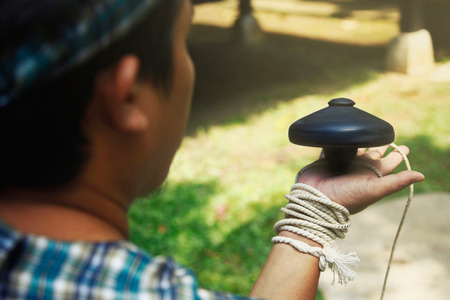 Man spinning top on his palmの写真素材