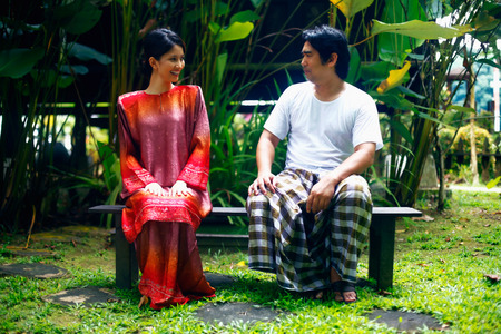Man and woman sitting on benchの写真素材