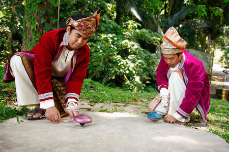 Two men playing with tops