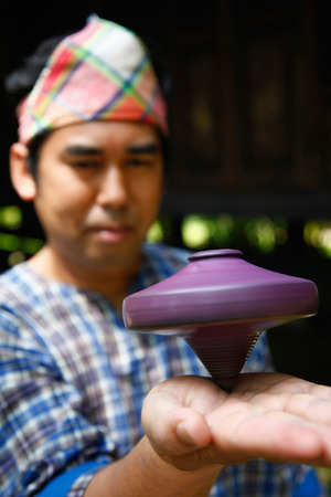 Man spinning top on his palmの写真素材