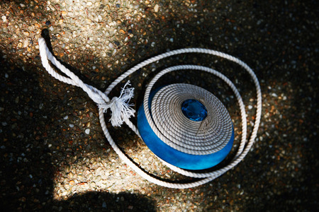 Blue top with string on the groundの写真素材