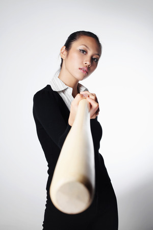 Businesswoman with baseball batの写真素材
