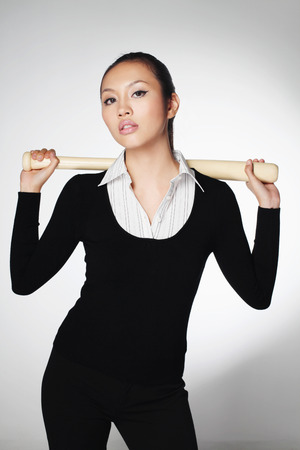 Businesswoman with baseball batの写真素材