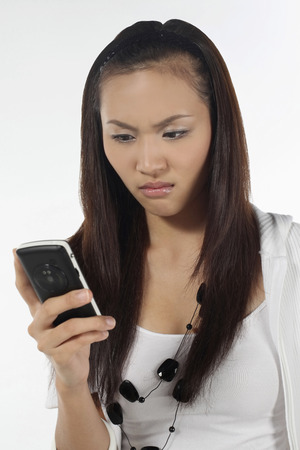 Woman text messaging on mobile phoneの写真素材
