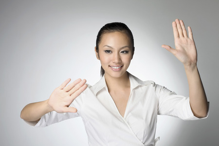 Businesswoman touching a high technology touch screen interfaceの写真素材