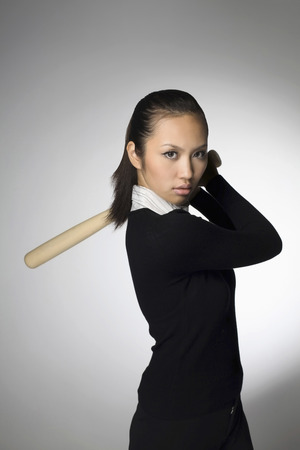 Businesswoman with baseball batの写真素材