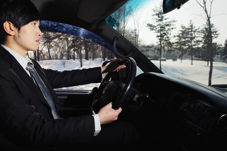 Businessman driving during winter time