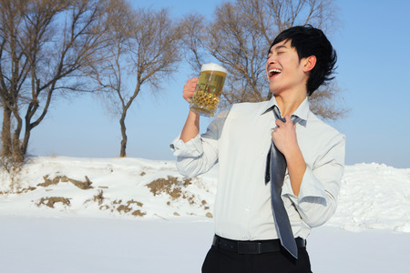 Businessman with a glass of beerの写真素材