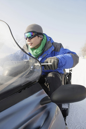 Man riding on snowmobileの写真素材