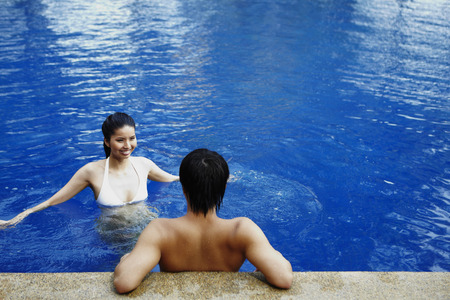 Man and woman relaxing in poolの写真素材