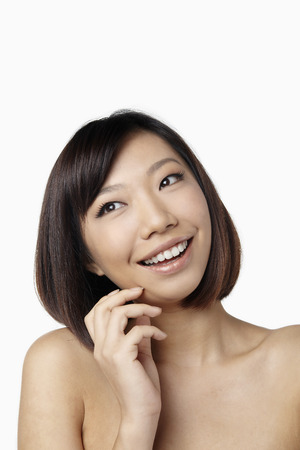 Woman smiling while looking awayの写真素材