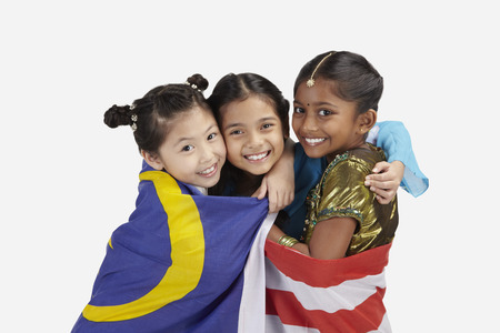 Happy girls with Malaysian flag wrapped around themの写真素材