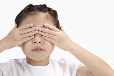 Girl covering her eyes with her handsの写真素材
