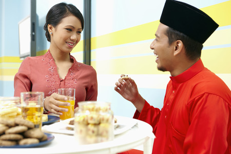 Man and woman talking while eatingの写真素材