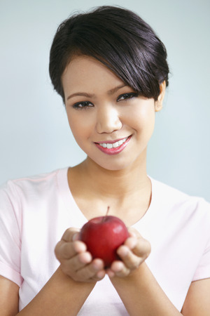 Woman with red appleの写真素材