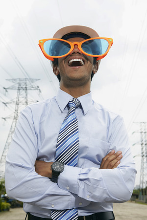 Young businessman wearing oversized sunglassesの写真素材