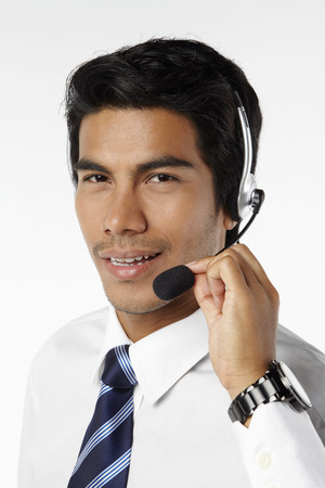 Young businessman wearing headsetの写真素材