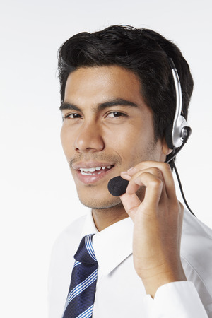 Young businessman wearing headsetの写真素材