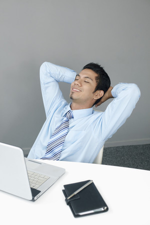 Young businessman taking a break from workの写真素材
