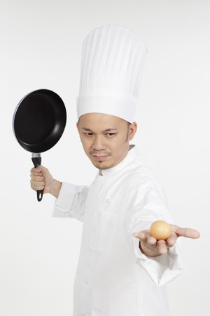 Asian chef venting out frustration on an eggの写真素材