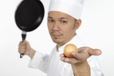 Asian chef venting out frustration on an eggの写真素材