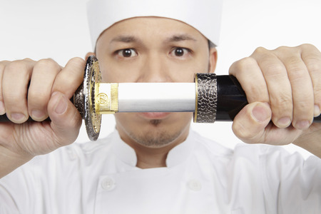 Asian chef with a samurai swordの写真素材