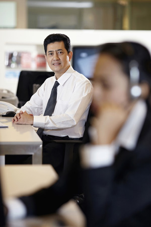 Businessman smiling and looking at the cameraの写真素材