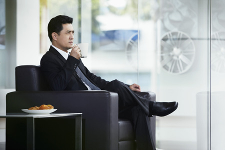 Businessman having a coffee breakの写真素材