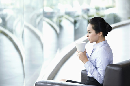 Businesswoman having a coffee breakの写真素材