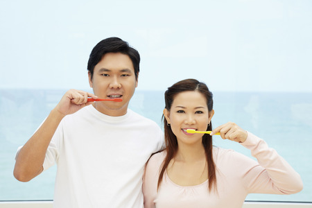 Man and woman brushing teethの写真素材